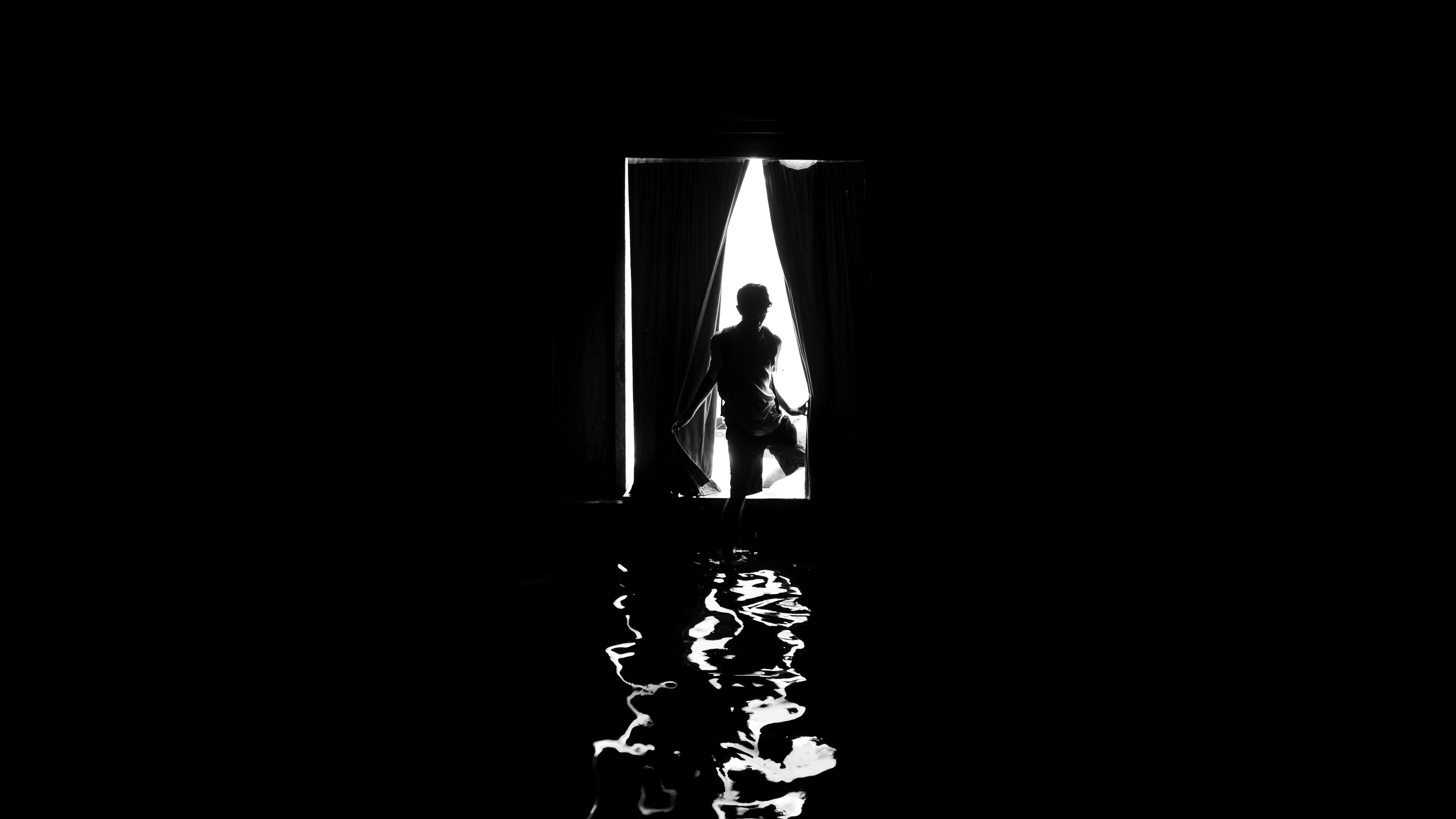 Silhouette in a doorway — black and white